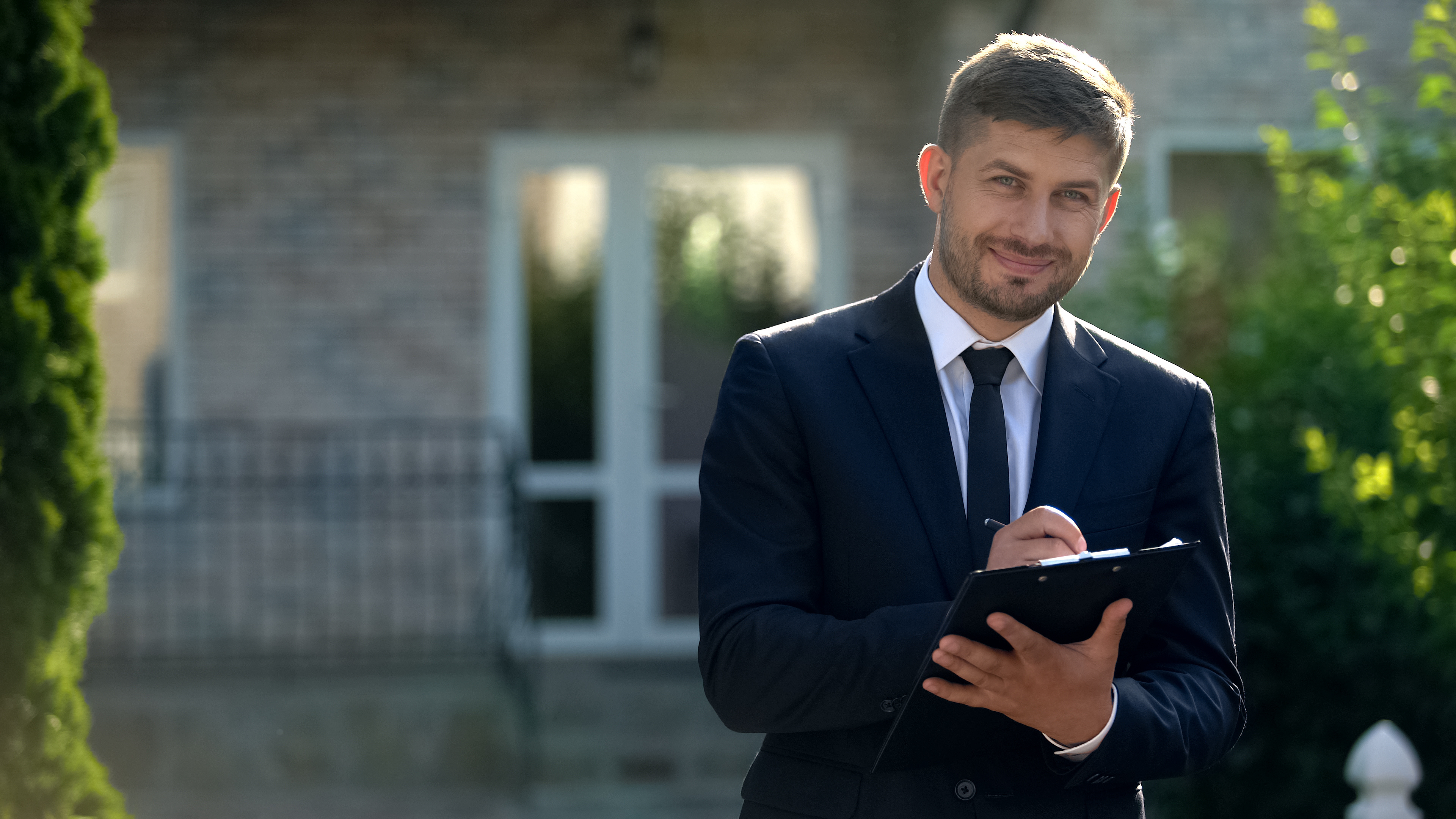 Male property manager outside double doors
