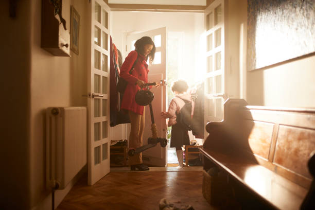 woman opening door for son